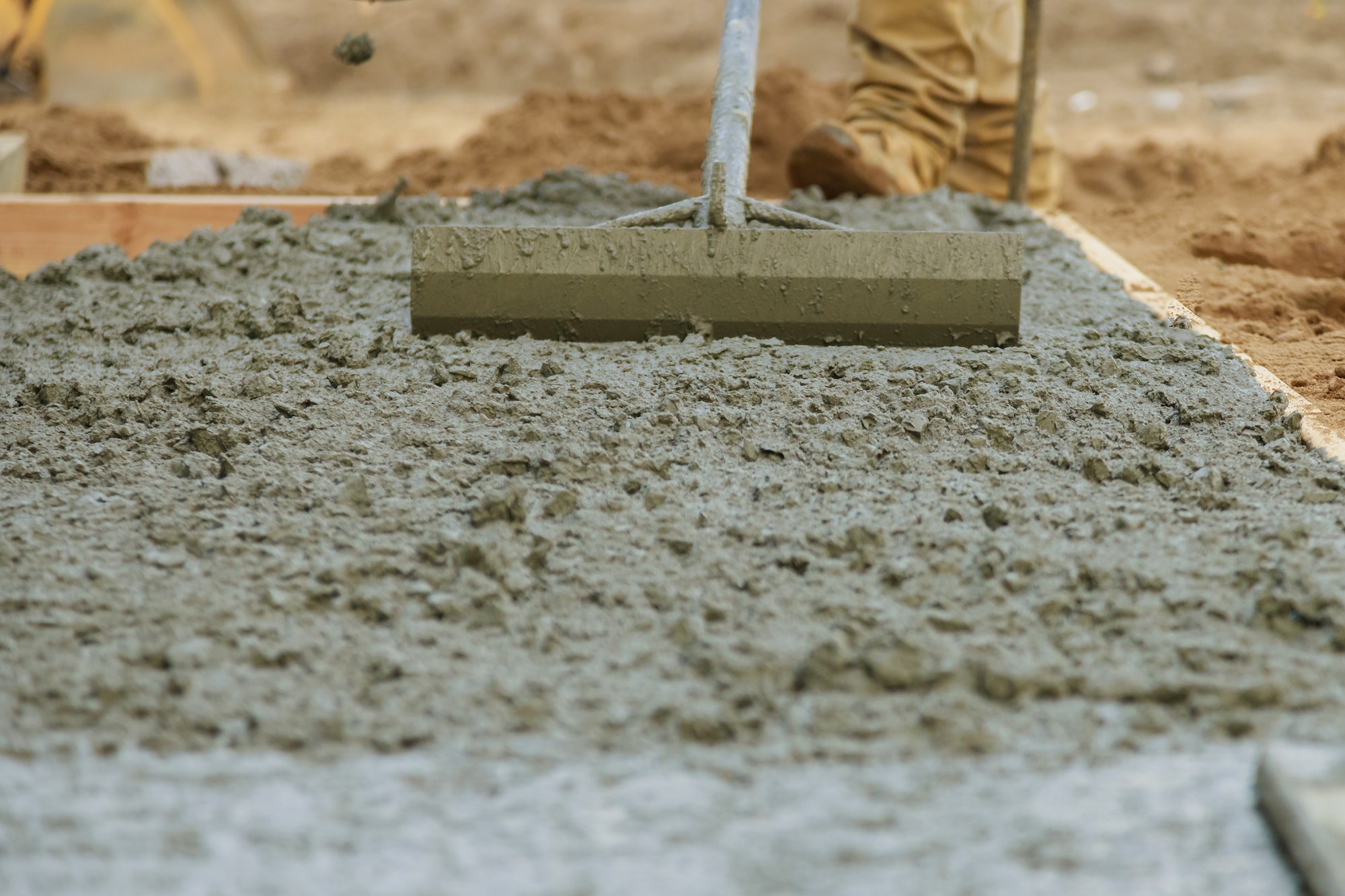 Cement pouring during concrete cement sidewalk in new residential home