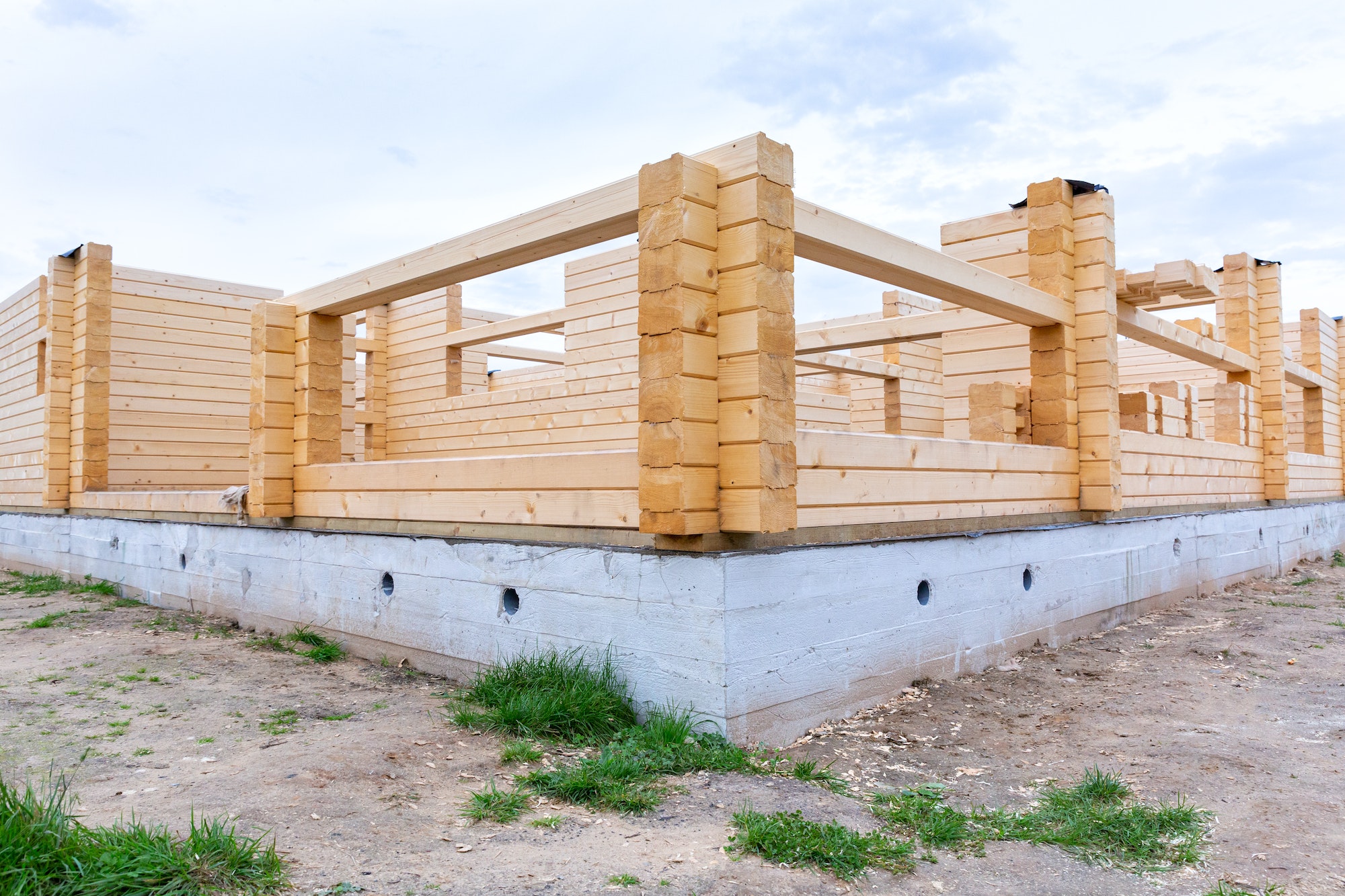 Construction of a wooden house on a cement base, foundation.