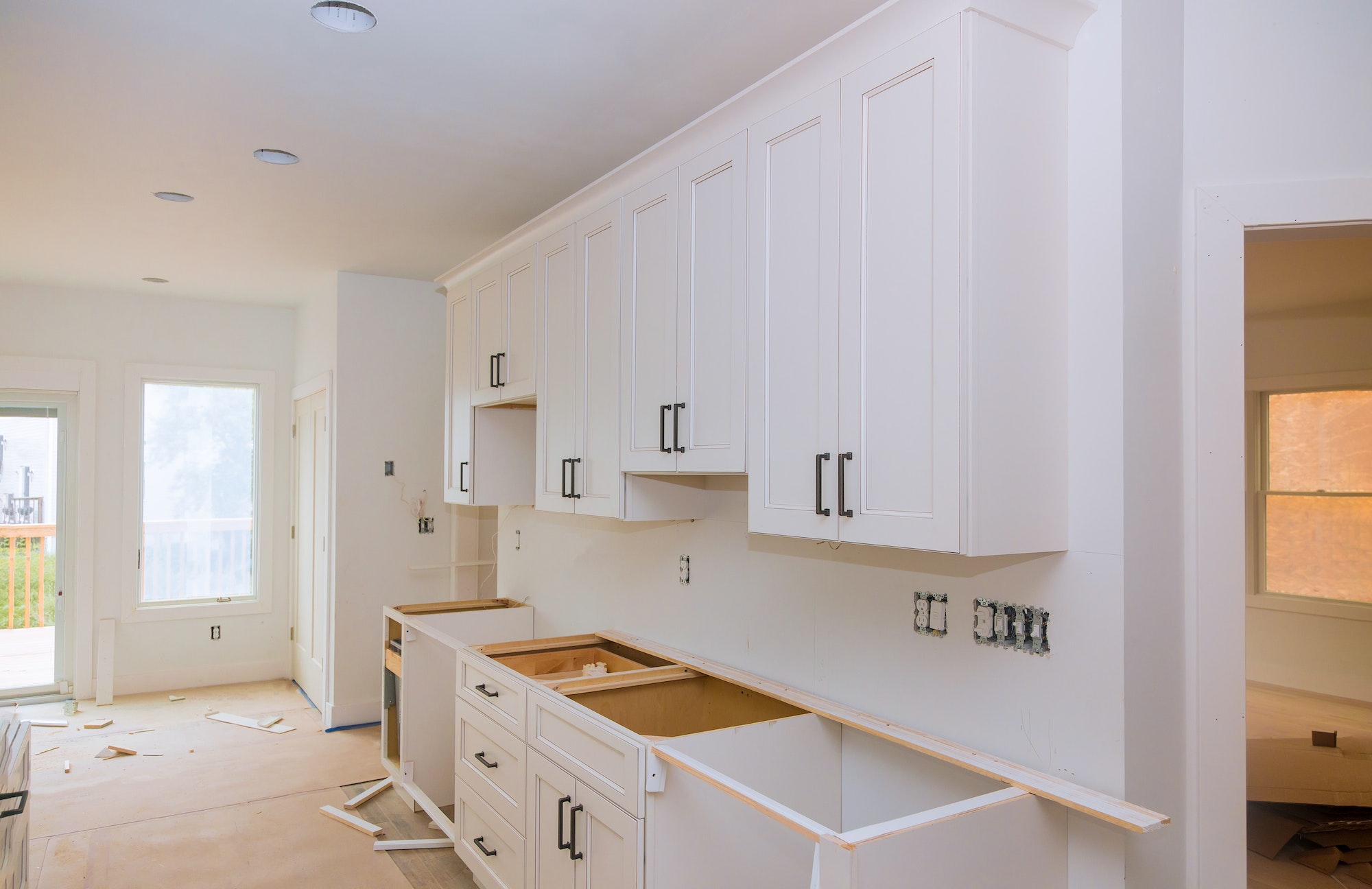 Custom kitchen cabinets in various stages of installation base for kitchen cabinets