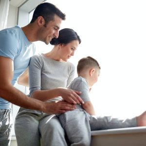 happy family looking through window at home